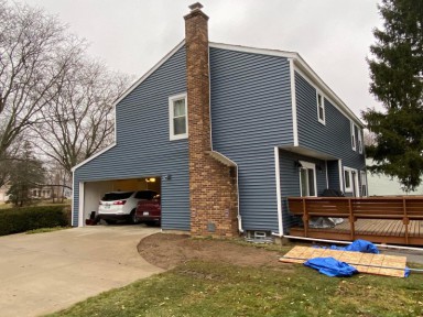 A home with new trim, fascia, and soffit installed by Michigan Exterior Pros.