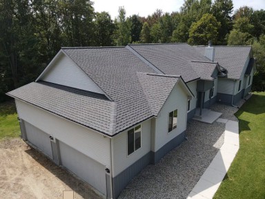 Fresh new rain gutters installed on a residential home by Michigan Exterior Pros.