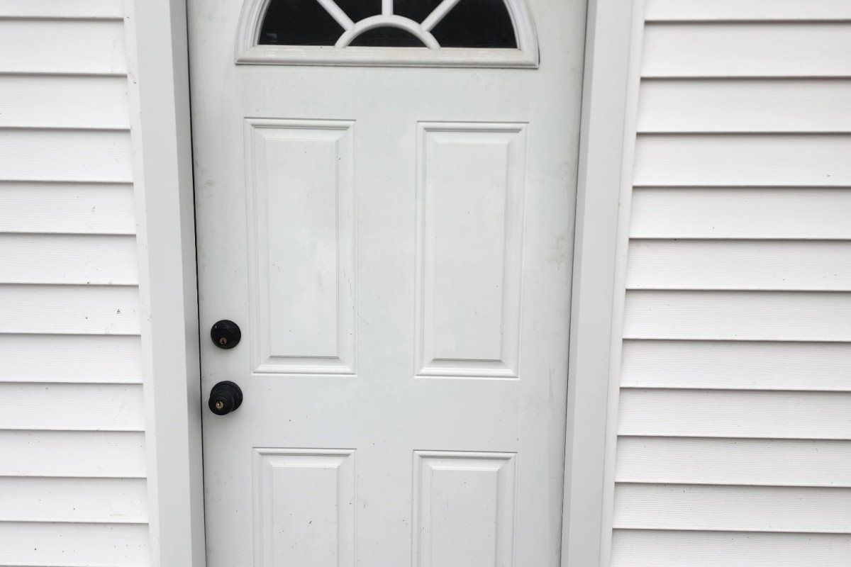 Wite entry door trim installed by Michigan Exterior Pros.