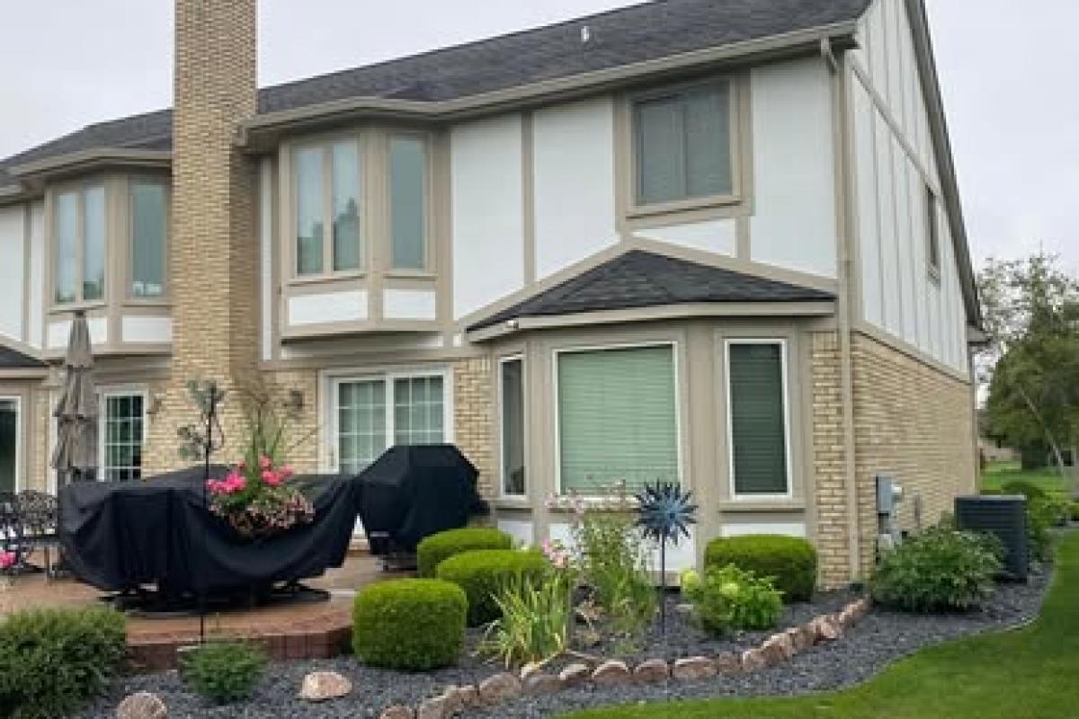 Freshly painted wood siding and bright white trim on a residential home