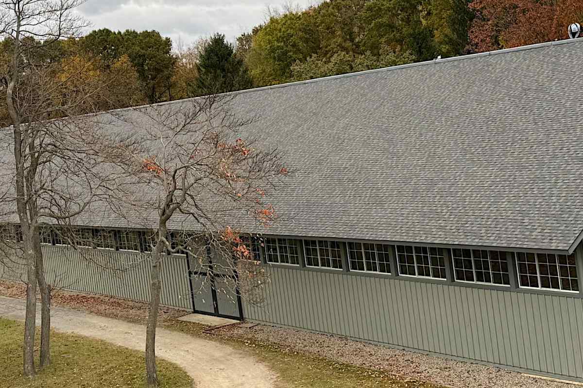 Full shingled roof replacement on a horse arena by Michigan Exterior Pros.