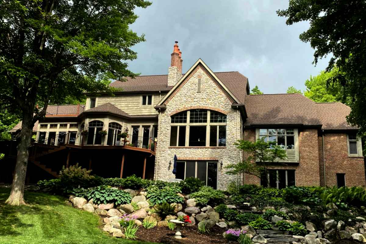 Shingled roof replaced on a large brick residential home by Michigan Exterior Pros.