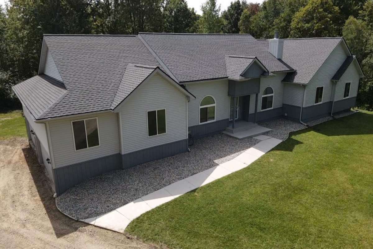 Shingle roof replaced by Michigan Exterior Pros on a residential home.