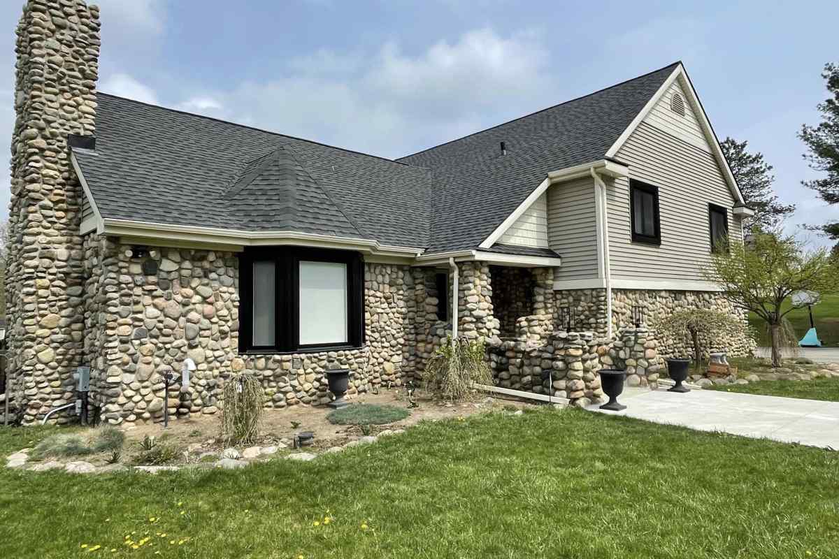 Fresh vinyl siding and new seamless gutters on a Michigan home