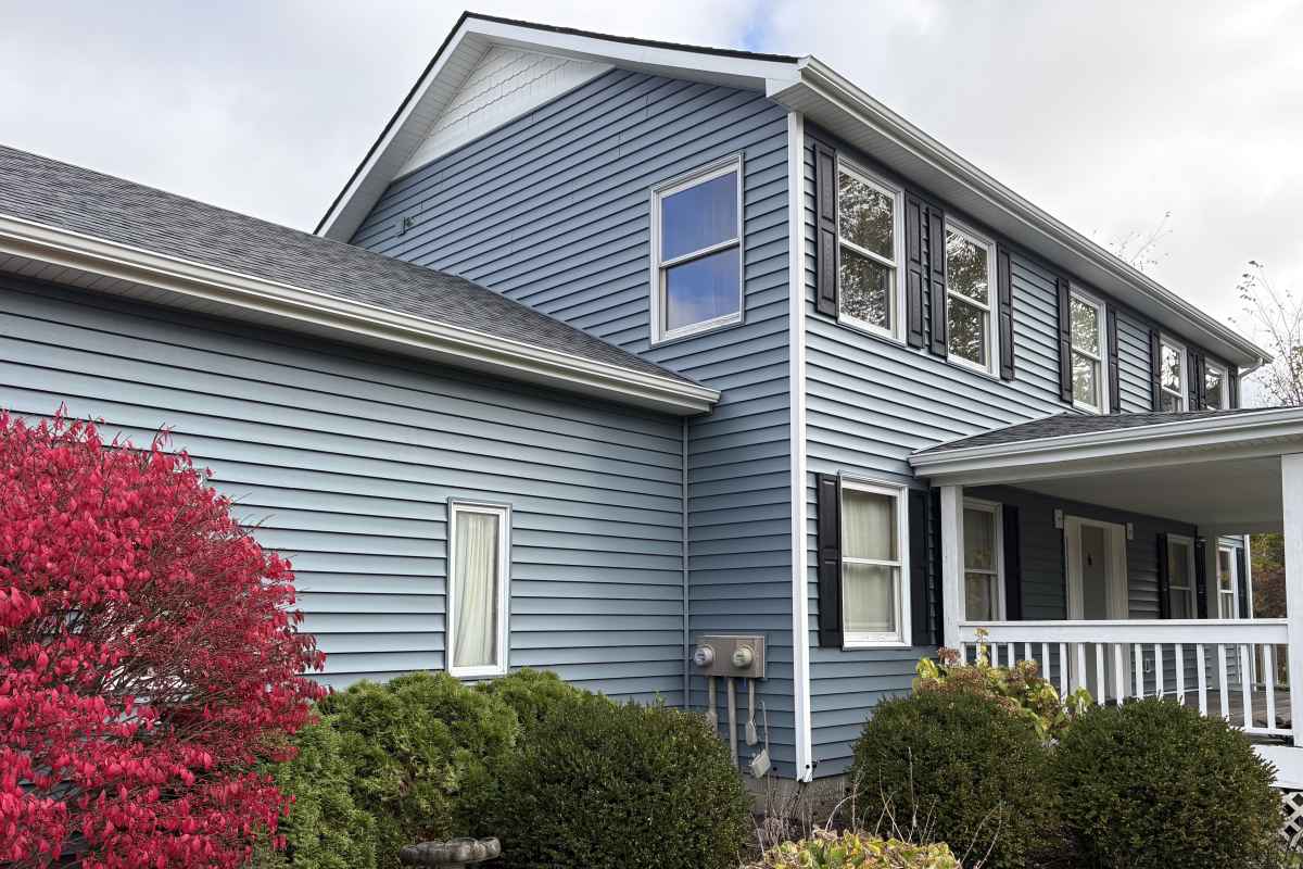 Lighty blue vinyl siding installed by Michigan Exterior Pros.