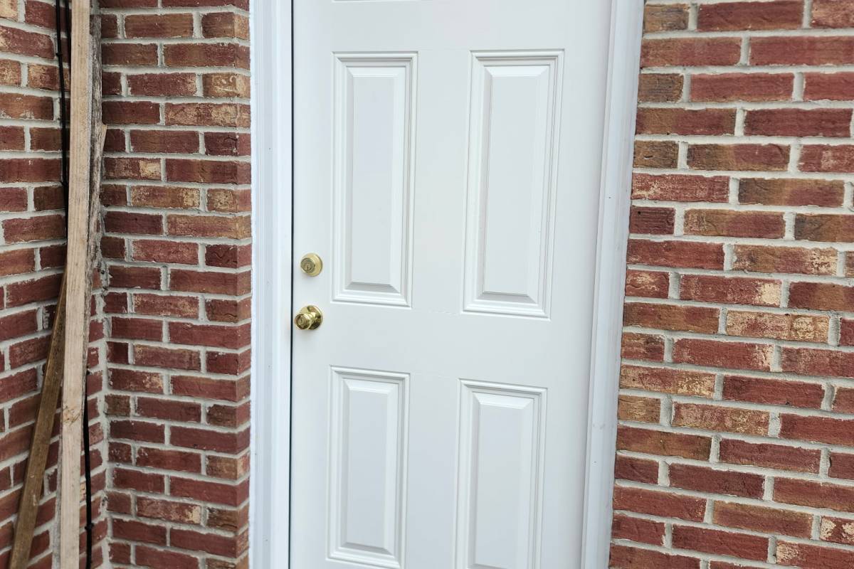 White entry doopr installed by Michigan Exterior Pros on a brick house.